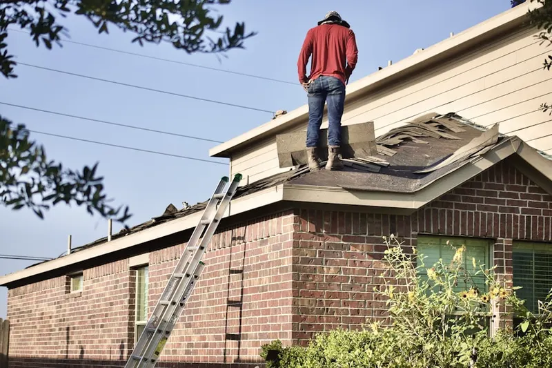 Professional roofer working on a residential roof in Flatiron Crossing